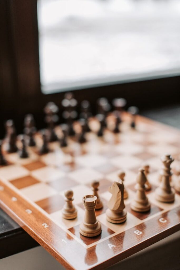 Close-up of a wooden chessboard with pieces, illustrating strategy in an indoor setting.